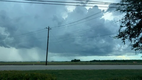 Motion time-lapse of a dark thunderstorm as traffic drives down a busy highway Stock Footage 93567225