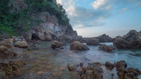 Motion time-lapse of sea waves hitting rocks as the sun goes down Stock Footage 119252713