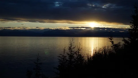 Motion Time-lapse of sunset over water and mountains in Alaska Stock Footage 102383833