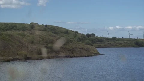 Motion Timelapse of Lake with Windmills in Background on West Coast of Cumbria Stock Footage 84448826