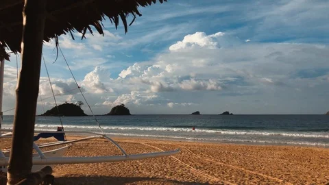 Motion Timelapse on a lonely sandy beach with a pavillion Stock Footage 103454226