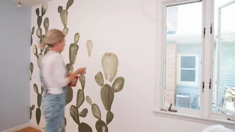 Motion Timelapse of Professional or DIY Female Painter Paiting Cactus on Wall Video stock 91519662