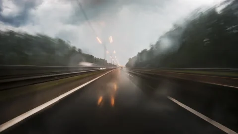 Motion timelapse of a speedy road drive along the highway in bad weather. Stock Footage 202136460