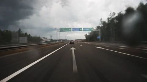 Motion timelapse of a speedy road drive along the highway in cloudy weather. Stock Footage 202147231