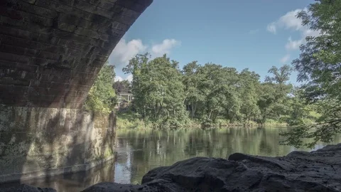 Motion Timelapse Underneath Sandstone Bridge Looking Out Towards Large River Stock Footage 84450346