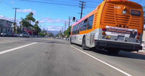 Motion tracking view of a public bus with passengers driving in in Los Angeles Vídeo Stock 250057747
