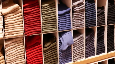 Motion of various kind of socks at display socks cabinet inside uniqlo store Video stock 105054007