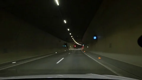 Motion view of car driving through illuminated tunnel. Stock Footage 80958239