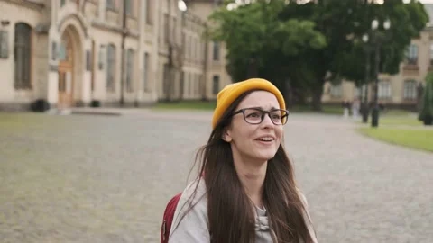 Motion view of teens meeting in front of university happily hugging each other Stock Footage 197746412