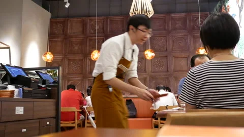 Motion of waiter handing receipt out for customer inside Chinese restaurant Stock Footage 95520745