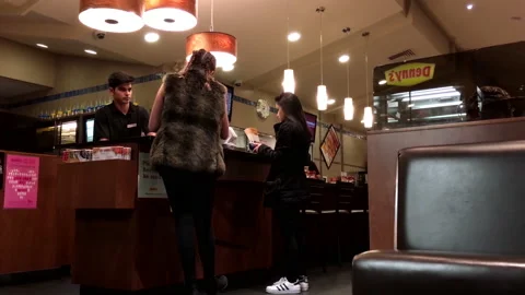 Motion of waiter printing bill for taking out customers inside Denny's Video stock 141144693