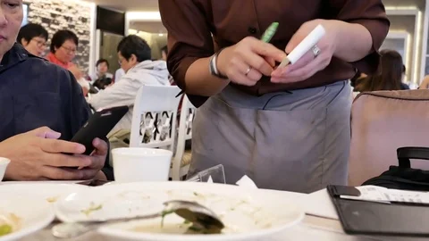 Motion of waitress taking order for customer inside Chinese restaurant Video stock 84289351