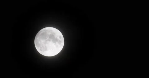 The motion of white full moon close up. The moon passing slowly through small th Video stock 168182076