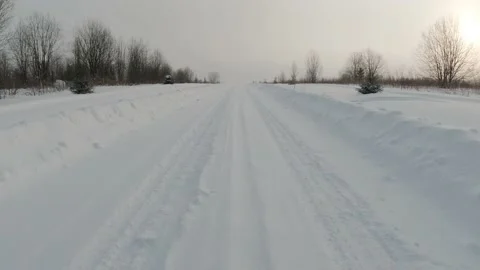 Motion on a white snow covered road in winter among the trees at sunset Stock Footage 152927745