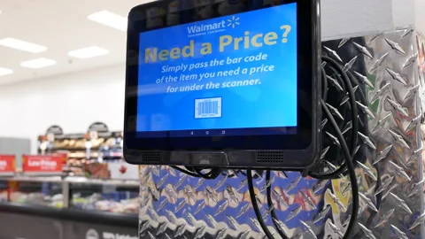 Motion of woma checking price at bar code scanner inside Walmart store 動画素材 108761289