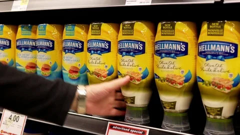 Motion of woman buying Hellmanns olive oil mayonnaise Stock Footage 74823207