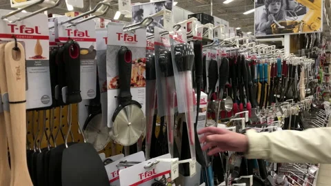 Motion of woman choosing cookware inside Canadian tire store Stock Footage 119802185