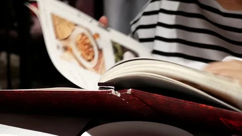Motion of woman looking at menu inside Shang Palace restaurant Video stock 81808347