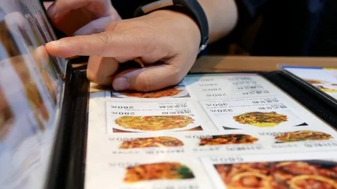 Motion of woman looking at menu inside Korean restaurant Video stock 81985398
