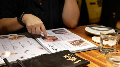 Motion of woman looking at menu inside Chinese restaurant with 4k resolution. Stock Footage 96557909