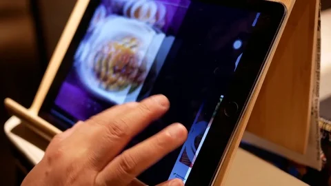 Motion of woman looking at menu at touch screen inside restaurant Video stock 81461653