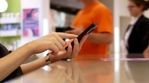 Motion of woman reading message on iphone at food court Stock Footage 78657834