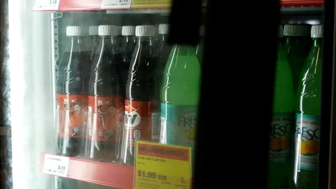 Motion of woman taking A&amp;W root beer from a cooler Stock Footage 74574786