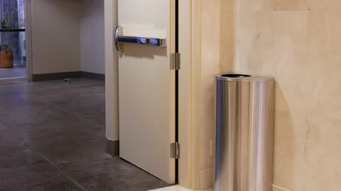 Motion of woman throwing trash to the garbage can inside shopping mall Stock Footage 102287054