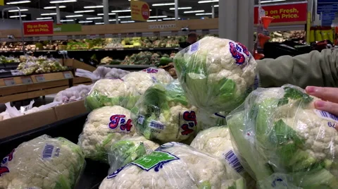 Motion of woman's hand picking cauliflower inside superstore Stock Footage 68577235
