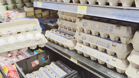 The motion of a woman's hand picking egg inside a Walmart 스톡 동영상 239635799