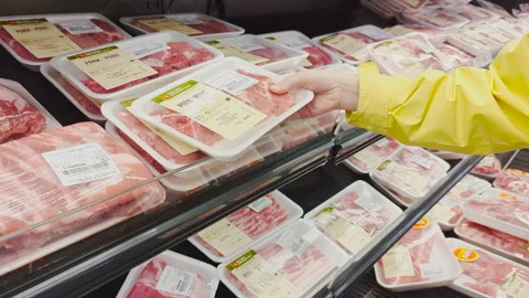 The motion of a woman's hand picking pork inside a superstore Stock Footage 238456924