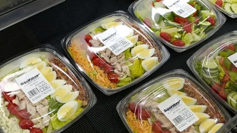 Motion of woman's hand picking salad inside superstore with 4k resolution Stock Footage 79985059