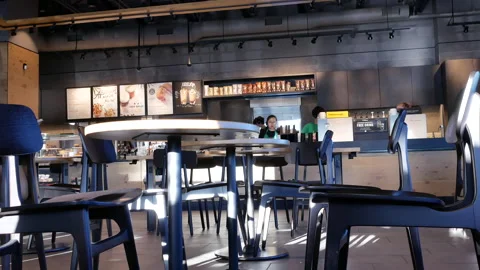 Motion of worker cleaning counter inside Starbucks store Video stock 91719335