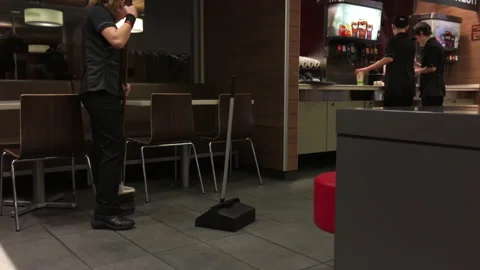 Motion of worker cleaning floor in front of self service soda machine Stock Footage 106214566