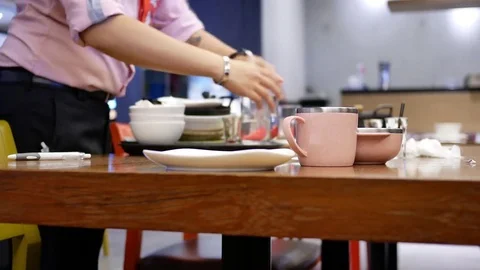 Motion of worker cleaning table after customer eating food inside restaurant Video stock 82634879