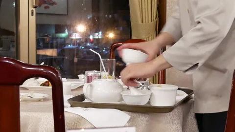 Motion of worker cleaning table after customer leaving the restaurant Stock Footage 107405382
