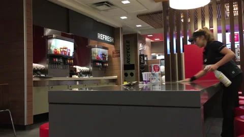 Motion of worker cleaning table at Mcdonalds fast food restaurant Stock Footage 106218455