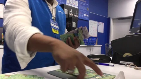Motion of worker counting money at customer service counter Stock Footage 80109428