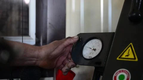 Motion to worker hand testing system pressure Stock Footage 143972104