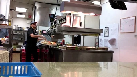 Motion of worker making hamburger for customer inside Burger king Stock Footage 70955165