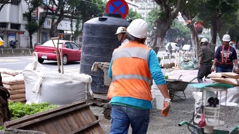 Motion of worker mixing cement for the preparation in construction site on road Stock Footage 83521501