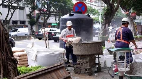Motion of worker mixing cement for the preparation in construction site on road Video stock 83525082