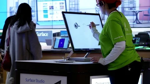 Motion of worker painting on new computer at Microsoft store Video stock 74425978
