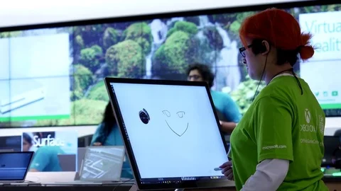 Motion of worker painting on new computer at Microsoft store Stock Footage 74869268