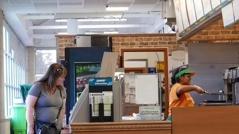 Motion of worker preparing sandwich for customer inside subway store Stock Footage 80353825