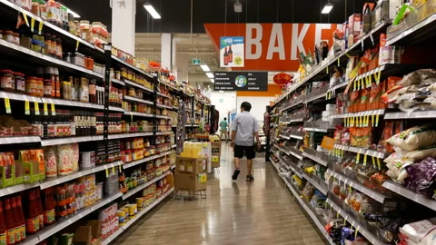 Motion of worker scanning price tag at sauce aisle Stock Footage 115484022