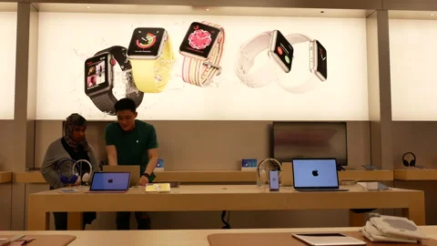 Motion of worker showing display iphone inside Apple store Video stock 89261474