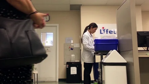 Motion of worker taking blood test sample inside medical office Video stock 80136297