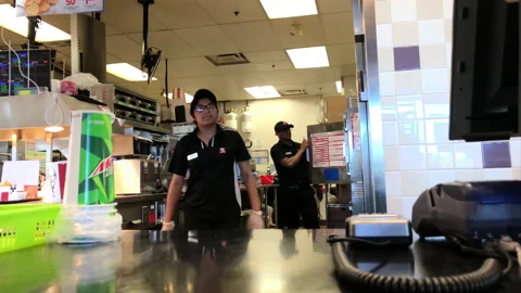 Motion of worker taking order at counter inside KFC restaurant Stock Footage 92514881