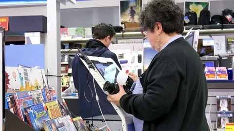 Motion of worker taking passport photo for customer and using computer Stock Footage 85103334